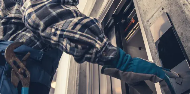 A man using the control panel on a lift